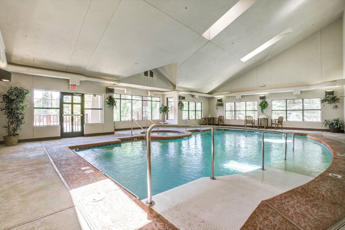An indoor swimming pool with natural lighting and spacious surroundings.