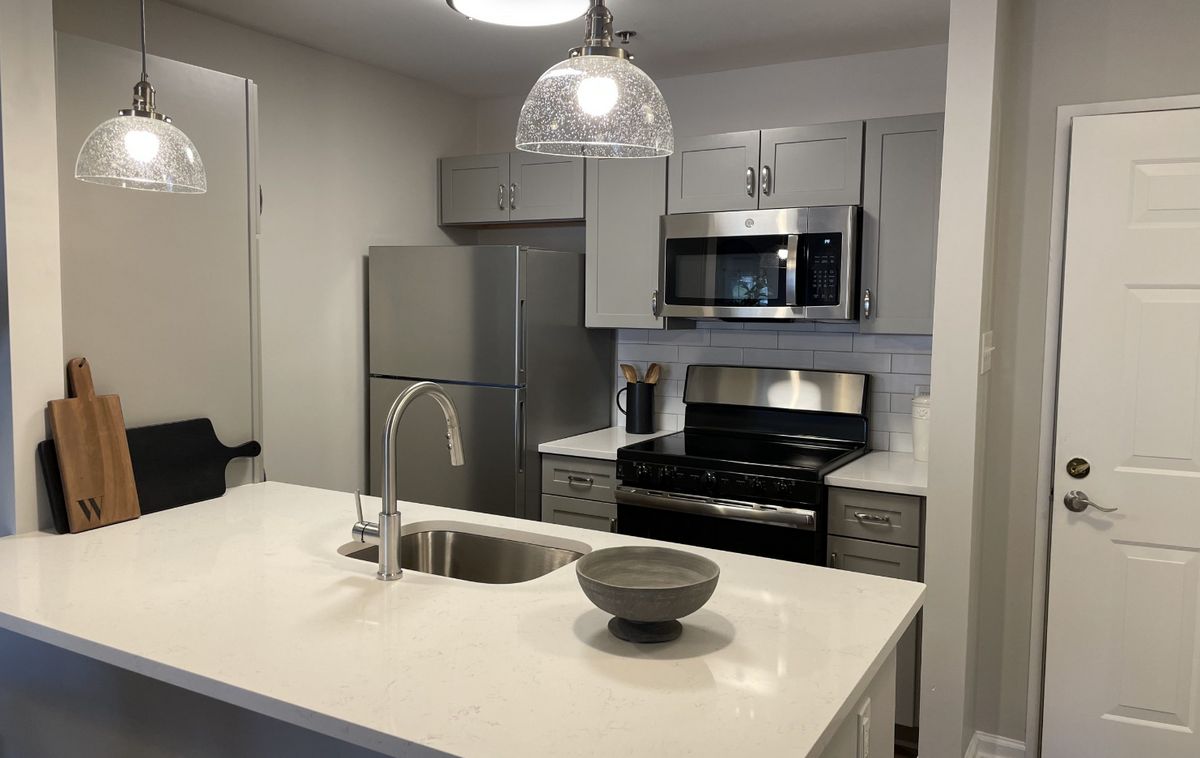 A modern kitchen featuring stainless steel appliances and a sleek countertop.