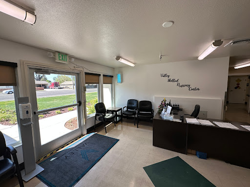 A modern waiting room featuring comfortable chairs and a welcoming reception area with natural light.