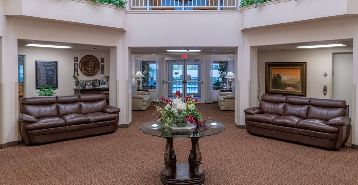 A spacious and elegantly decorated lobby area with comfortable seating and a central table display.