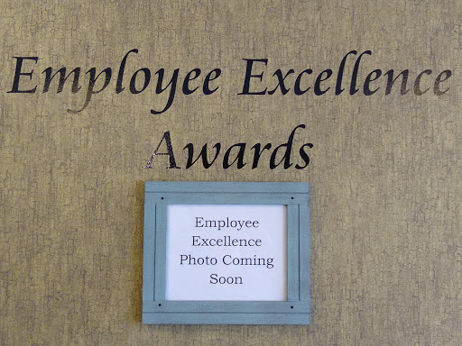 A display board announcing upcoming Employee Excellence Awards with a note about photo updates.