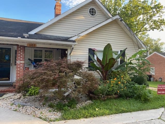 A charming suburban house with a well-maintained garden and vibrant greenery.
