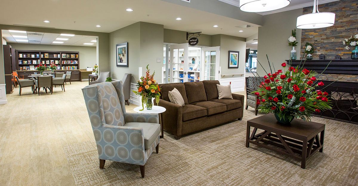 Modern lobby with comfortable seating and floral arrangements.