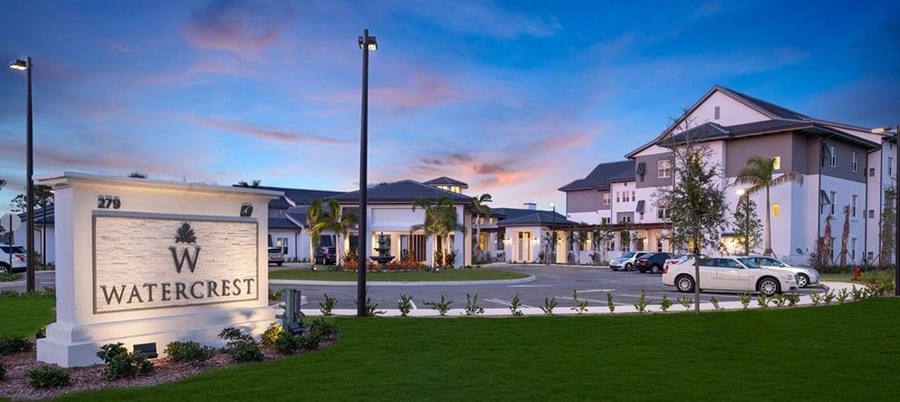 A luxurious residential complex with modern architecture at sunset.