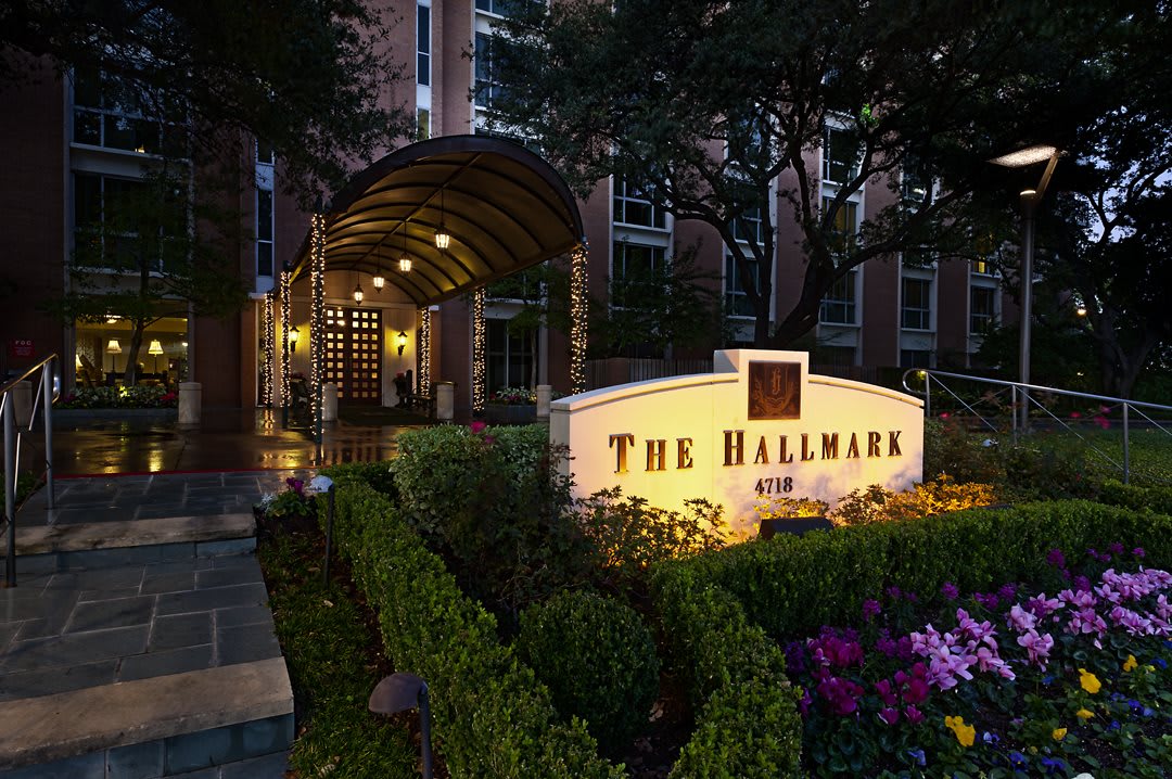 Elegant entrance of The Hallmark building illuminated at night.