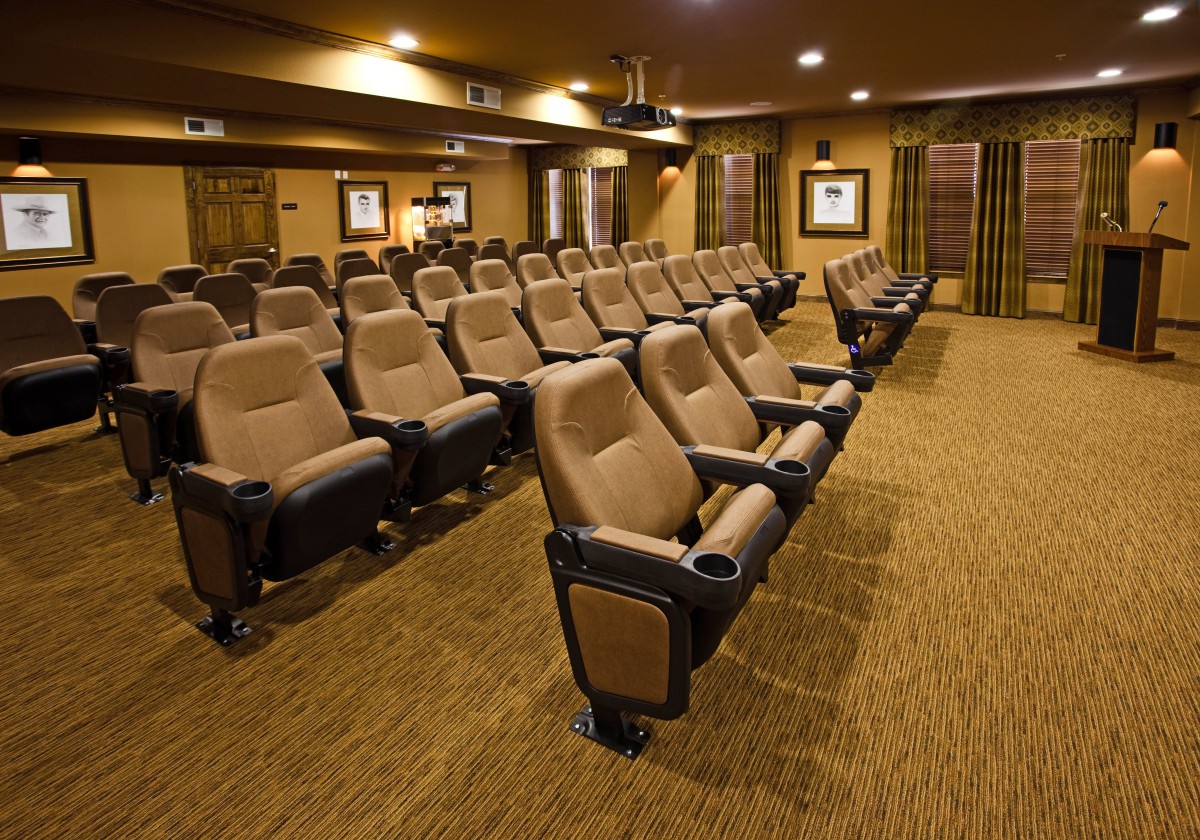 A luxurious home theater with rows of comfortable seating.