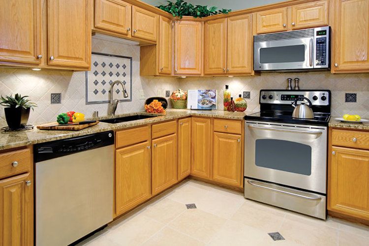 A modern kitchen with wooden cabinets and stainless steel appliances.