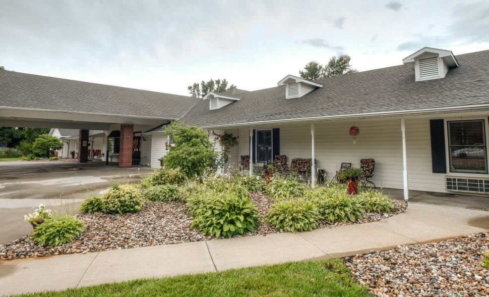 A charming residential house with a landscaped front yard and a welcoming porch.