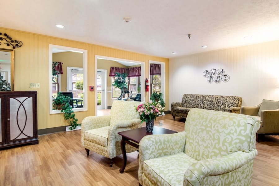 A cozy living room with comfortable seating and decorative elements.