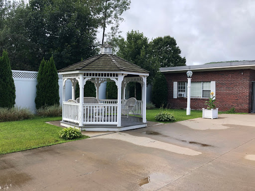 A charming gazebo surrounded by greenery, providing a perfect spot for relaxation.