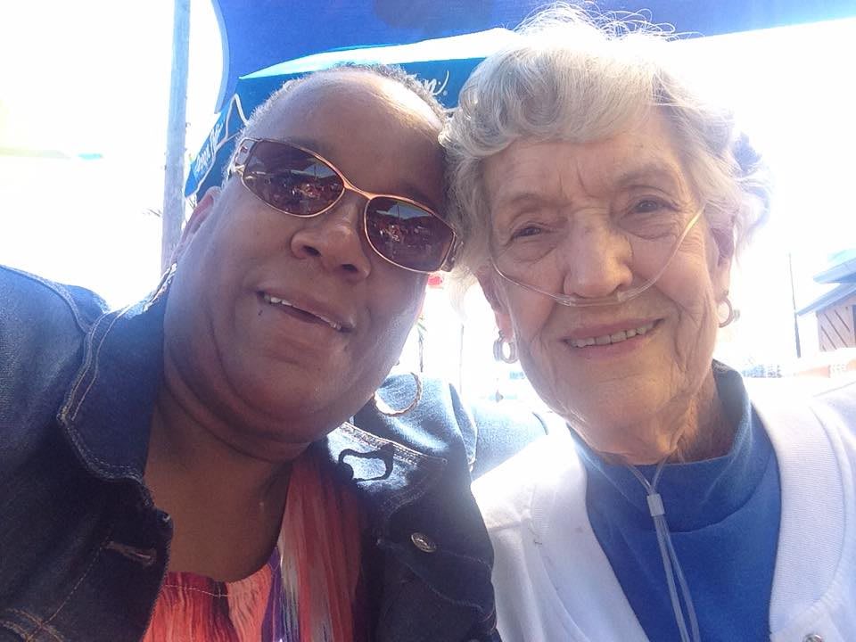 Two people smiling together in an outdoor selfie.