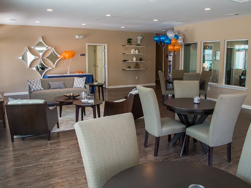 A modern lounge area with comfortable seating and decorative elements, including balloons and wall art.