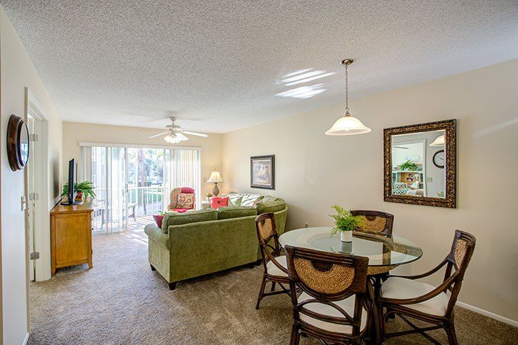 A cozy living and dining space with modern furniture and ample natural light.