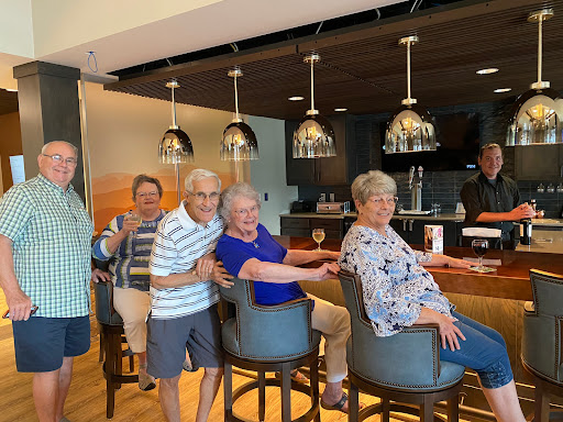 A cheerful gathering of friends enjoying time together at the bar.