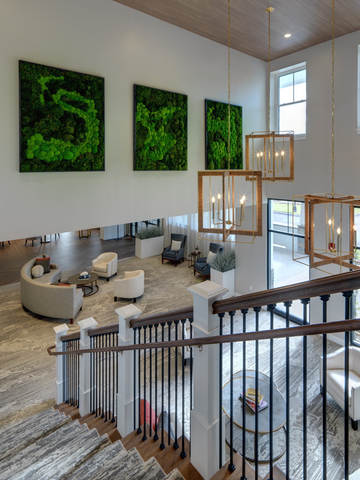 A modern lobby with a spacious seating area, contemporary artwork, and elegant chandeliers.