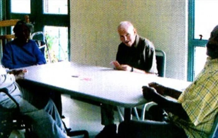 A group of people gathered around a table engaged in discussion.