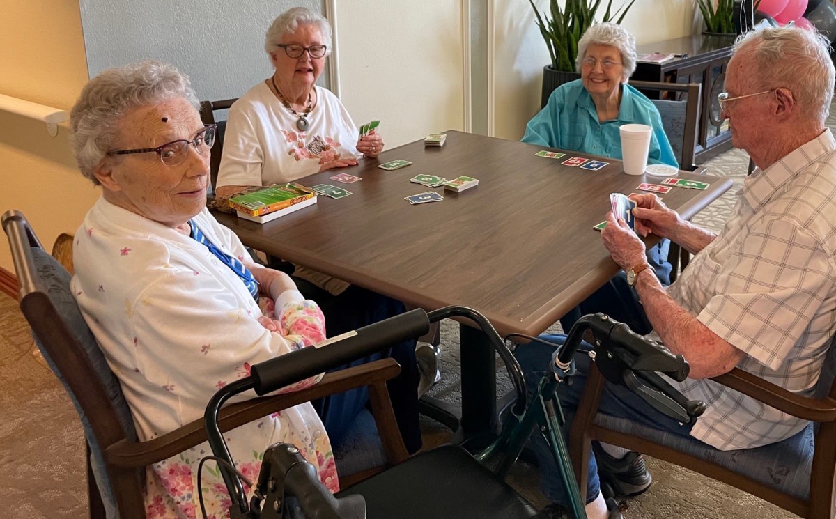 A group of elderly women enjoying a card game together.