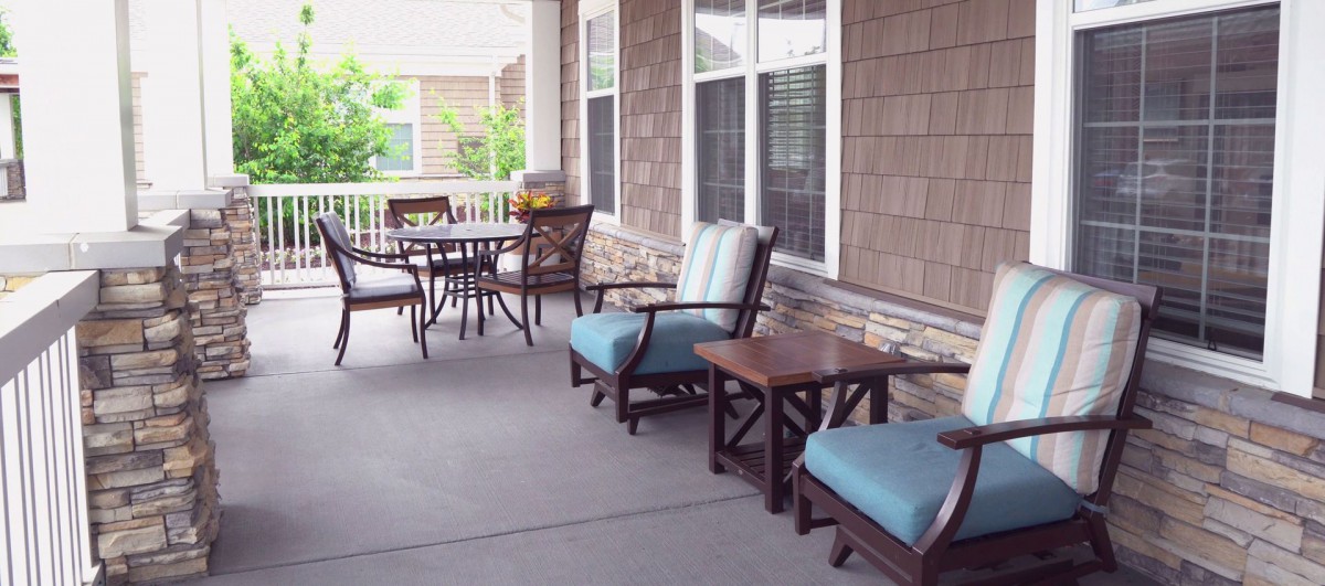 A cozy porch with comfortable seating and tables, perfect for relaxation.
