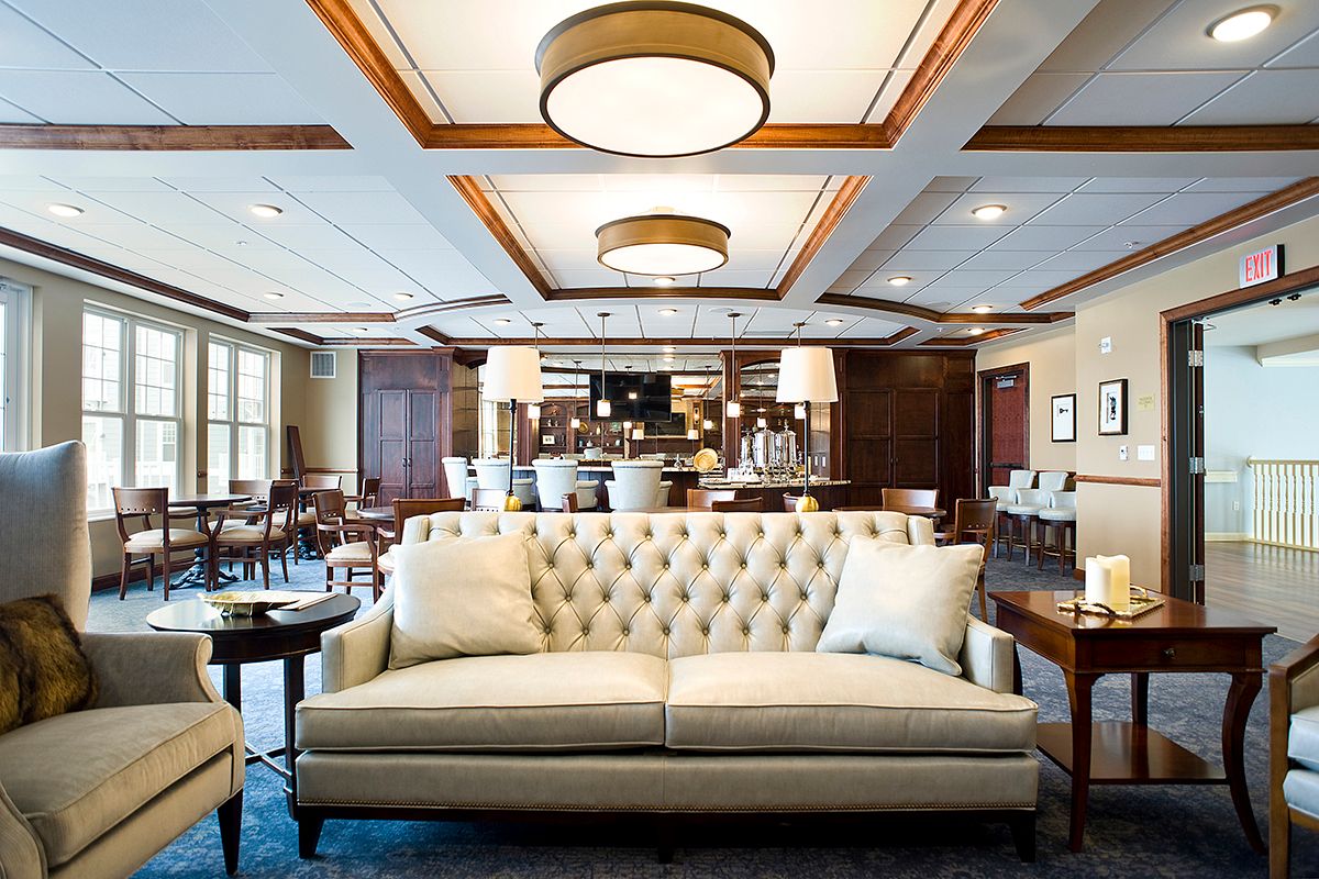 Elegant lounge area with comfortable seating and a sophisticated bar in the background.