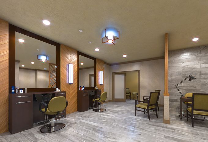 A modern salon interior with stylish chairs, mirrors, and ambient lighting.