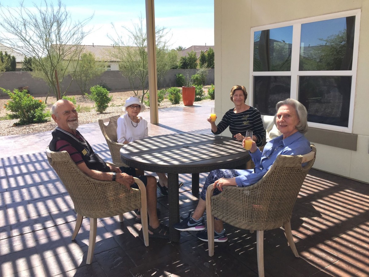 A group of people enjoying a relaxing time together on a sunny patio.