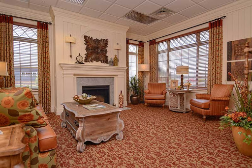 A cozy living room featuring warm tones, a stylish fireplace, and comfortable seating.
