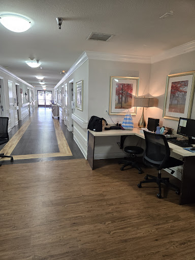 A modern office space featuring workstations along a spacious hallway.