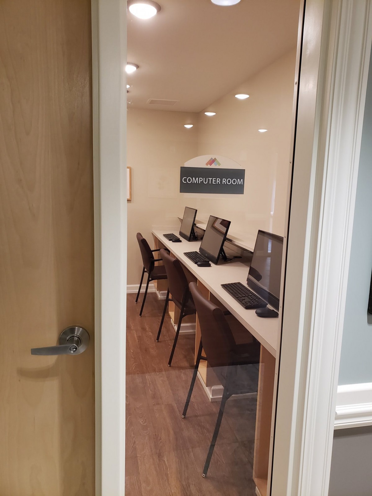 A small computer room with several workstations set up for use.