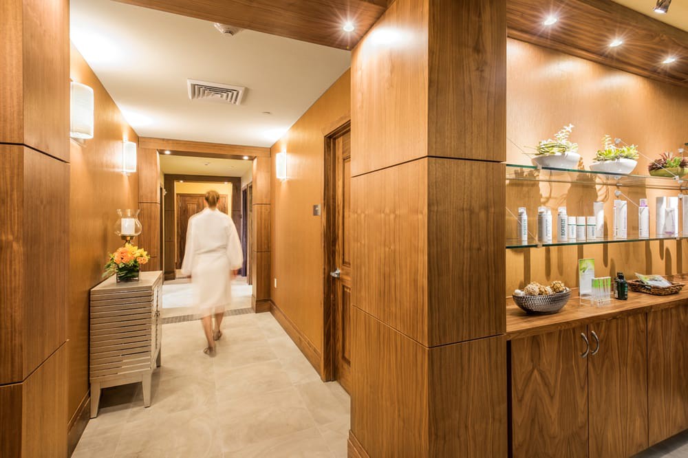 A luxurious spa hallway with wood paneling and elegant decor, creating a relaxing ambiance.