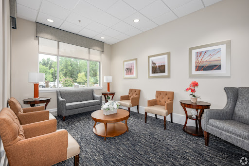 A serene waiting area designed for comfort and relaxation, featuring modern furniture and natural lighting.