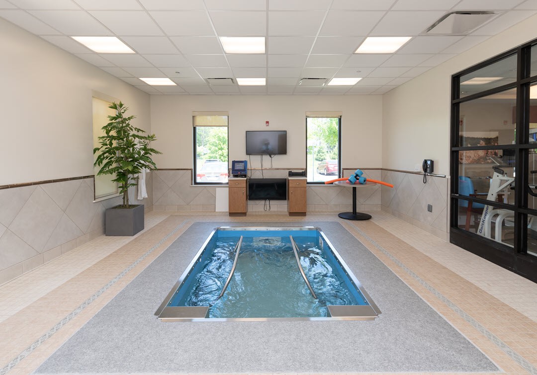 A modern indoor therapy pool designed for rehabilitation and exercise.