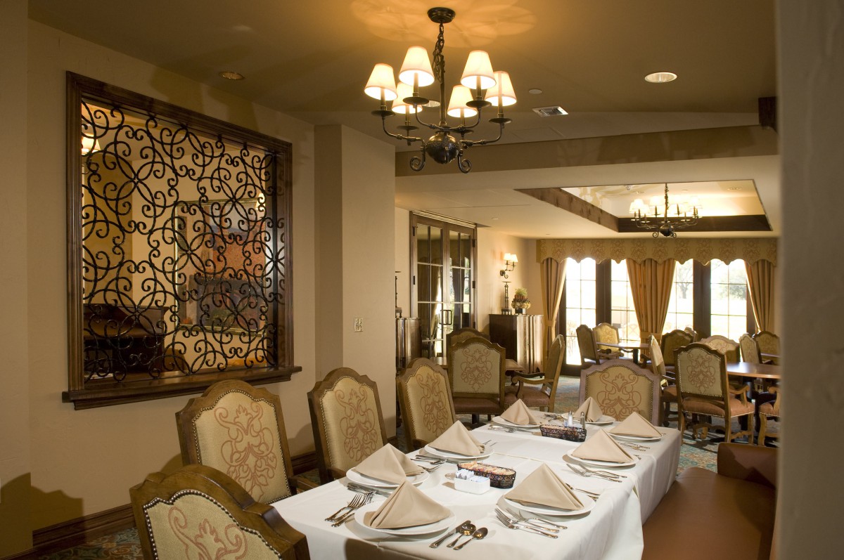 An elegantly designed restaurant dining room with a neatly set table.