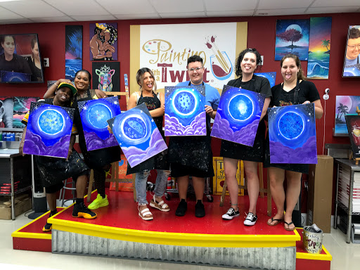 A vibrant art class where participants showcase their colorful paintings, celebrating creativity and collaboration.