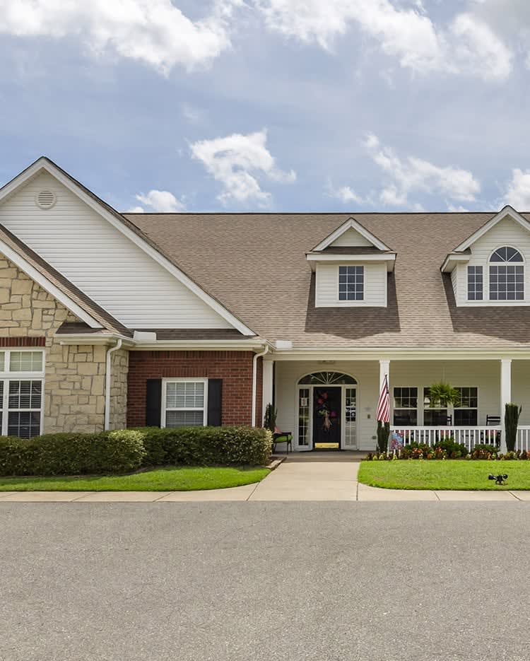 A suburban residential house with a well-kept lawn and driveway.