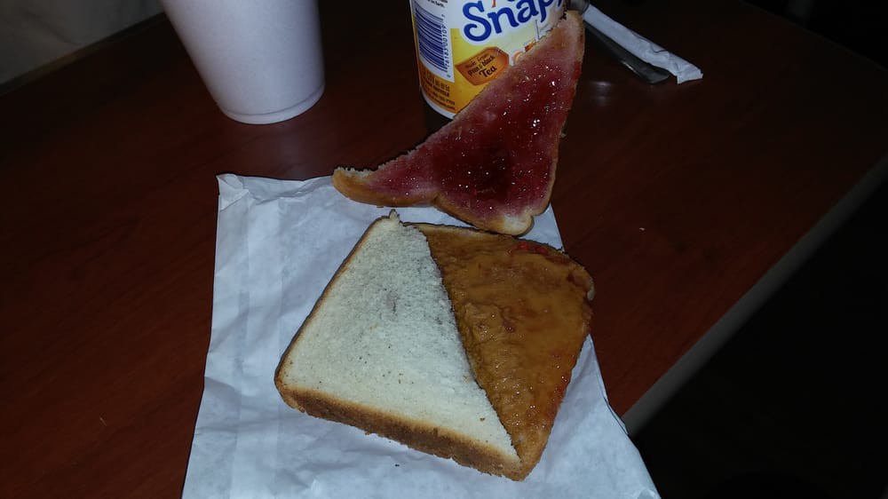 A simple snack featuring toast with jelly and a slice of watermelon.