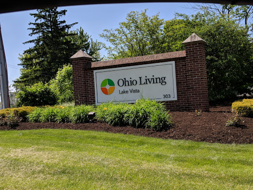 Entrance sign for Ohio Living, surrounded by lush greenery.