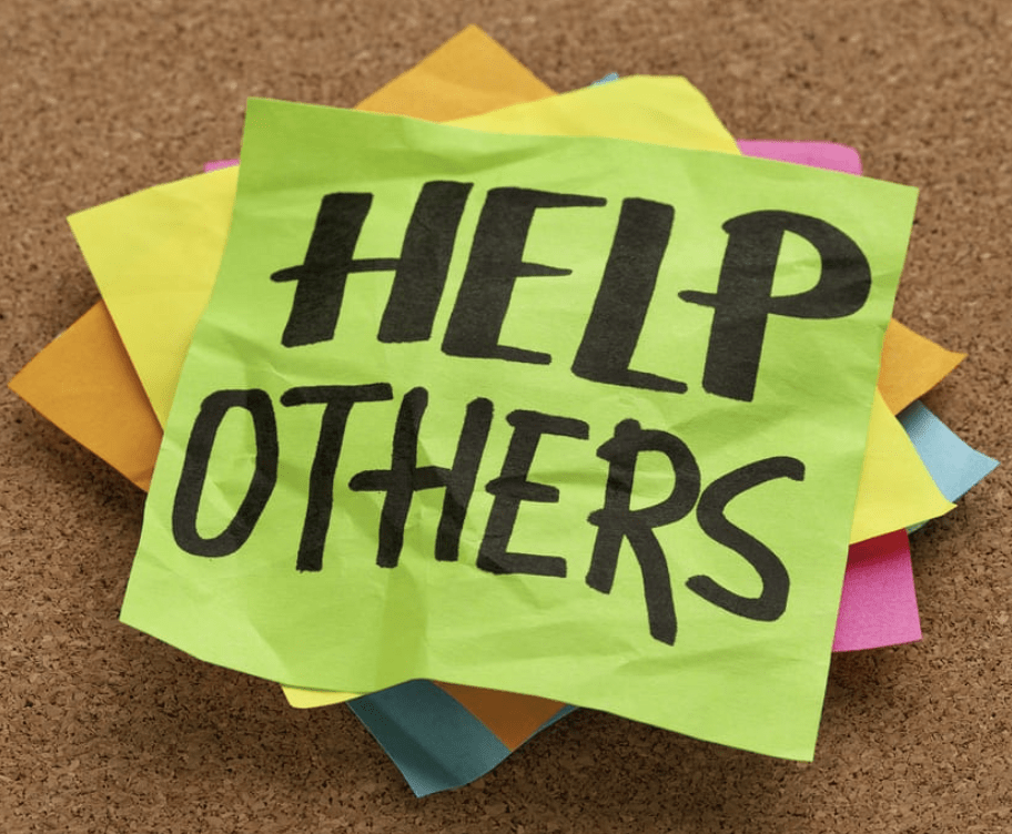 A stack of colorful sticky notes with 'HELP OTHERS' written on the top note.