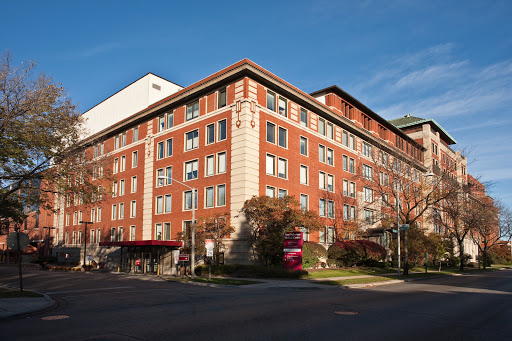 A red brick building featuring a modern architectural design, bathed in daylight.