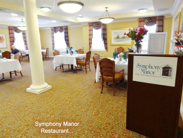 A view of the Symphony Manor restaurant with elegantly arranged tables and chairs.