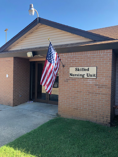Entrance of a Skilled Nursing Unit with an American flag.