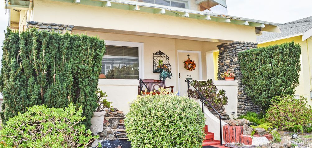 A welcoming front porch adorned with plants and seasonal decorations.