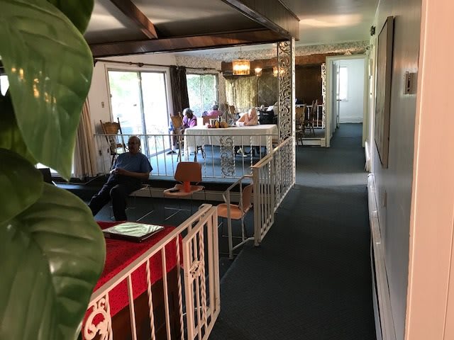A group of people gathered in a casual meeting space inside a building.