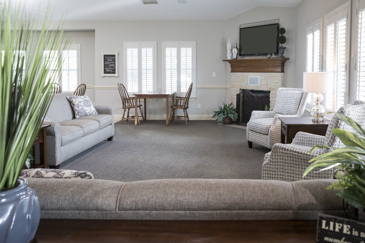 A spacious living room with cozy seating and a fireplace.