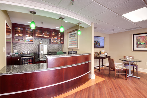 A modern reception area featuring a stylish bar and comfortable seating.