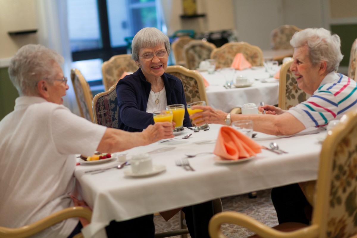 A group of elderly women enjoying a meal together at a restaurant.