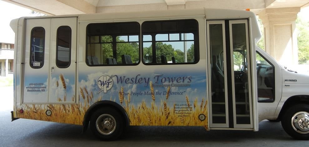 A bus displaying an advertisement for Wesley Towers.