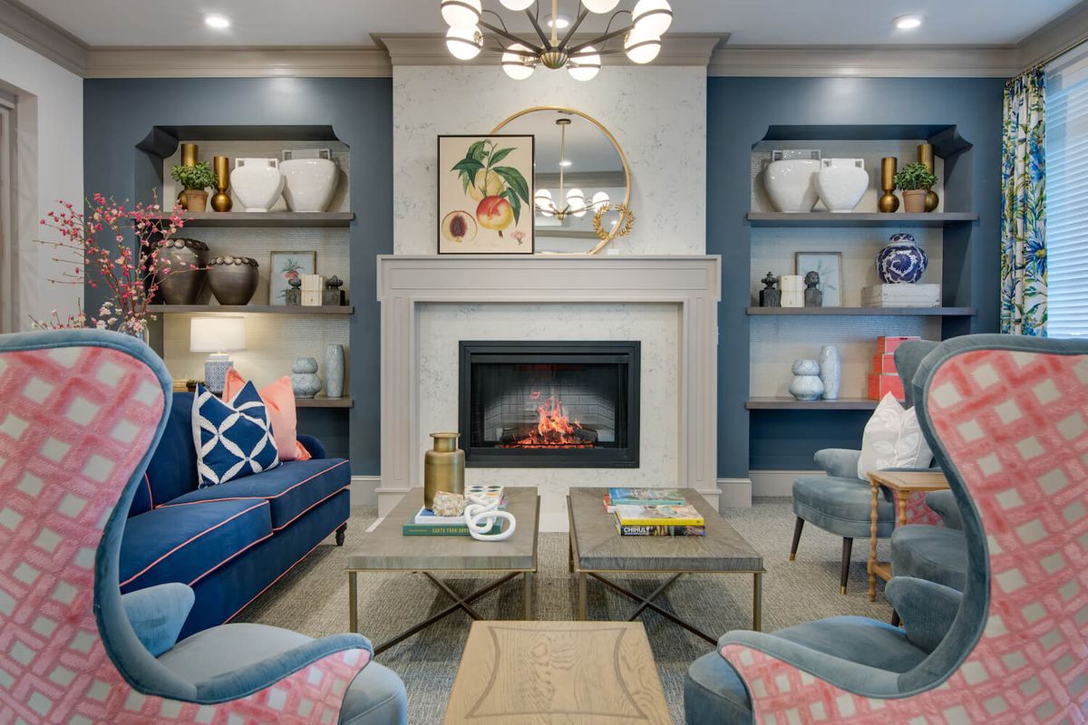 A modern living room with a cozy fireplace and stylish decor.