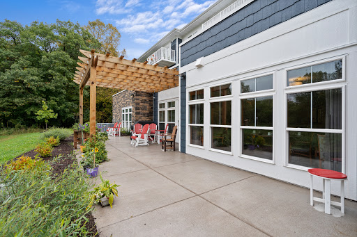 A serene outdoor patio area featuring a pergola and modern design elements, perfect for relaxation.