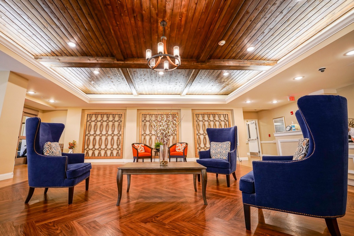 A spacious and elegant lobby with comfortable seating and a stylish wooden ceiling.