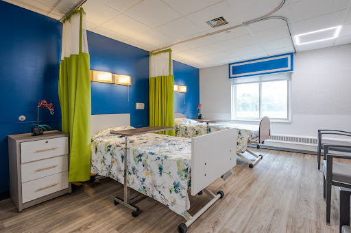 A modern hospital patient room featuring clean lines and bright colors.